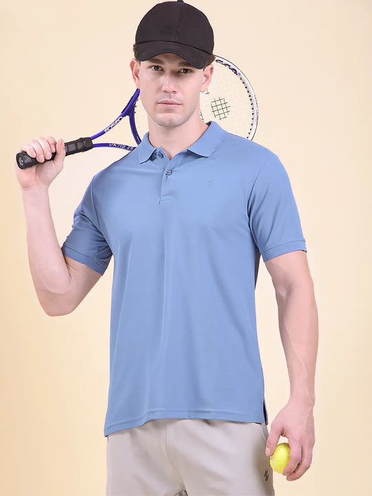 Man holding a tennis racket and ball, wearing a light blue polo t-shirt (DCYPHR Men&